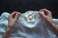 Fresh homemade mozzarella cheese in cheesecloth on the black background. Top view.