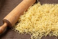 Fresh homemade noodles and wooden kitchen rolling pin