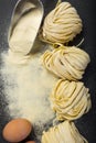 Fresh homemade pasta with pasta ingredients on the dark background Royalty Free Stock Photo