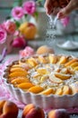 Fresh Homemade Peach Tart Sprinkled with Powdered Sugar on Kitchen Counter with Pink Flowers