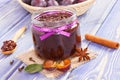Fresh plum marmalade in jar, spices and ripe fruits in wicker basket, healthy sweet dessert Royalty Free Stock Photo