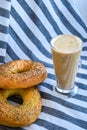 Fresh homemade Poppy bagels bread with cup of coffee, latte machiato or cocoa, cappuccino, breakfast time, Crispy crunchy bagel