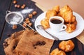 Fresh homemade profiteroles on the kitchen table. French pastries.