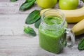 Fresh homemade raw vegetable and fruit green smoothie in mason jar with apple, banana and spinach Royalty Free Stock Photo
