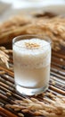 Fresh Homemade Rice Milk in Clear Glass with Organic Grains on Bamboo Mat, Healthy Vegan Beverage Concept Royalty Free Stock Photo