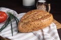 Fresh homemade rye bread, tomato, bunch onion, clay mug and bottle of milk on wooden cutting board Royalty Free Stock Photo