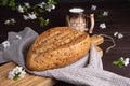 Fresh homemade rye cereal bread with clay mug of milk on wooden cutting board. Healthy breakfast Royalty Free Stock Photo