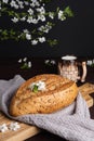 Fresh homemade rye cereal bread with clay mug of milk on wooden cutting board. Healthy breakfast Royalty Free Stock Photo