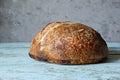 Fresh homemade sourdough bread with whole grain flour on a gray-blue background. Royalty Free Stock Photo