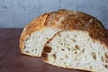 Fresh homemade sourdough bread with whole grain flour on a on a gray-brown background. Royalty Free Stock Photo