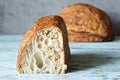 Fresh homemade sourdough bread with whole grain flour on a gray-blue background. Royalty Free Stock Photo