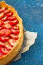 Fresh homemade strawberry shortcrust tart pie stuffed with custard vanilla cream . Sliced berries and mint leaf on the trendy