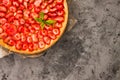 Fresh homemade strawberry shortcrust tart pie stuffed with custard vanilla cream . Sliced berries and mint leaf on the trendy dark Royalty Free Stock Photo