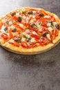 Fresh Homemade Vegetarian Greek Pizza with feta and vegetables closeup on the wooden board. Vertical Royalty Free Stock Photo