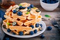 Fresh homemade waffles with blueberries and banana for breakfast Royalty Free Stock Photo