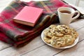 Fresh homemade warm chocolate chip cookies with tea to relax and enjoy a good book on cold winter day