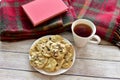 Fresh homemade warm chocolate chip cookies with tea to relax and enjoy a good book on cold winter day