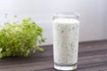 Fresh homemade yogurt kefir, ayran in glass with herbs. Ayran, homemade yogurt drink with herbs and cucumbers - healthy summer