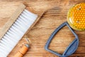 Fresh honey in the comb and the tools of the beekeeper on a brawn vooden background. Flat lay and top view Royalty Free Stock Photo