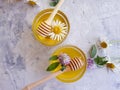 Fresh honey, daisy flower refreshment dessert on concrete background Royalty Free Stock Photo