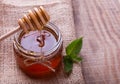 Fresh honey flowing down on a spoon at glass jar Royalty Free Stock Photo