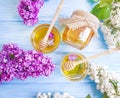 Fresh honey natural healthy spring heather lilac flower compositionon wooden background