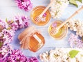 Fresh honey natural healthy spring heather lilac compositionon wooden background