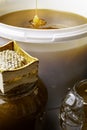 fresh honey in white bucket and in glass jar, with honeycomb Royalty Free Stock Photo