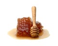 Fresh Honeycomb slice and wooden honey dipper isolated on white background Royalty Free Stock Photo