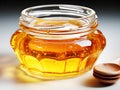 Fresh honeycombs in glass jar. Liquid honey with honeycomb and honey dipper in glass jug Royalty Free Stock Photo