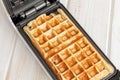 Fresh hot belgian waffles cooked in a waffle iron