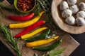 Fresh hot chili peppers lie on a wooden cutting board on a black table Royalty Free Stock Photo