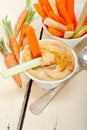 Fresh hummus dip with raw carrot and celery