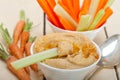 Fresh hummus dip with raw carrot and celery Royalty Free Stock Photo