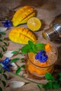 Fresh Ice mango soda drink decorate by Blue Butterfly Pea Flower and mint on the wood table there are mango slice, lemon, cocktail Royalty Free Stock Photo