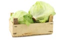 Fresh iceberg lettuce in a wooden crate