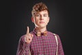 Fresh idea! Attention! Handsome young man in vintage shirt and curly hair keeping finger raised and looking at camera Royalty Free Stock Photo