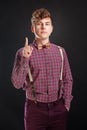 Fresh idea! Attention! Handsome young man in vintage shirt and curly hair keeping finger raised and looking at camera Royalty Free Stock Photo