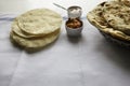 Fresh Indian flat breads Naans and poppadums served on the white cloth Royalty Free Stock Photo