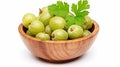 Fresh Indian gooseberry fruits in wooden bowl with green leaves on white background. generative ai Royalty Free Stock Photo