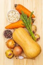 Fresh ingredient for pumpkin soup. Pumpkin, onion, carrot, potato, spices, seeds, pepper mix, salt, dill. Vegetables on wooden Royalty Free Stock Photo