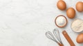 Fresh Ingredients for Baking with Eggs, Flour, and Kitchen Tools on Marble Surface Royalty Free Stock Photo
