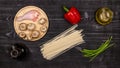 Fresh ingredients for cooking home-made fried noodles on a black rustic wooden table. Top view Royalty Free Stock Photo
