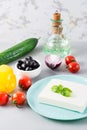 Fresh ingredients for homemade Greek salad on the table. Domestic life. Vertical view Royalty Free Stock Photo