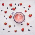 Fresh ingredients for smoothies and electric blender on white wooden background, top view . Superfoods health or detox diet