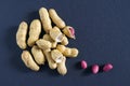 Fresh inshell peanuts on a dark surface