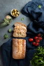 Fresh italian ciabatta bread cut  slices with tomato, basil and olive on dark background. Top view  and copy space Royalty Free Stock Photo