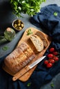 Fresh italian ciabatta bread cut  slices with tomato, basil and olive on dark background. Top view  and copy space Royalty Free Stock Photo