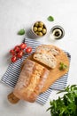 Fresh italian ciabatta bread cut  slices with tomato, basil and olive on white background. Top view  and copy space Royalty Free Stock Photo