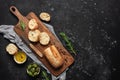 Fresh Italian ciabatta bread with olive oil, olives and rosemary on a black stone background. Top view, flat lay Royalty Free Stock Photo